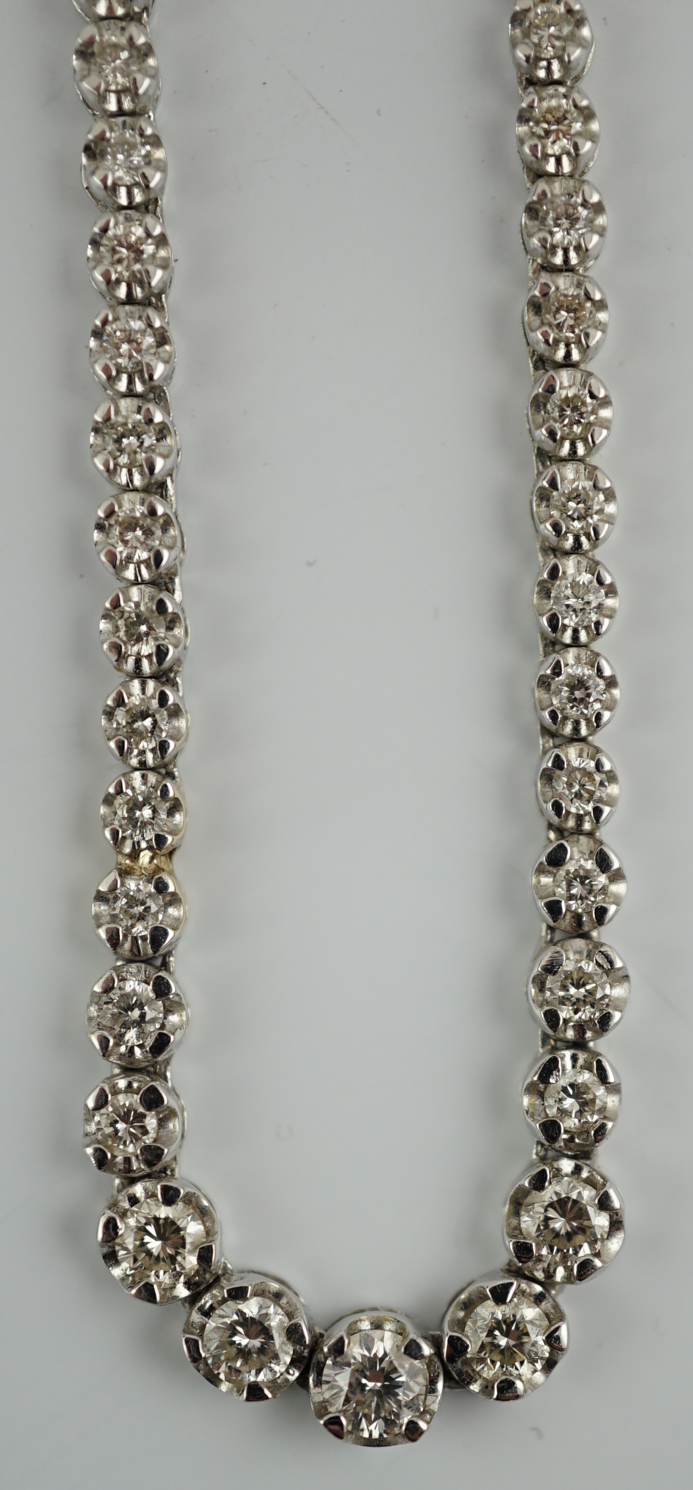 A modern 18k gold and illusion set diamond line necklace